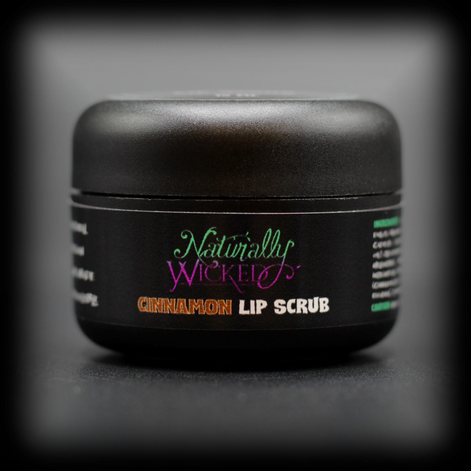 Naturally Wicked Cinnamon Lip Scrub With Natural & Vegan Ingredients In Luxury Black Container On Dark Background