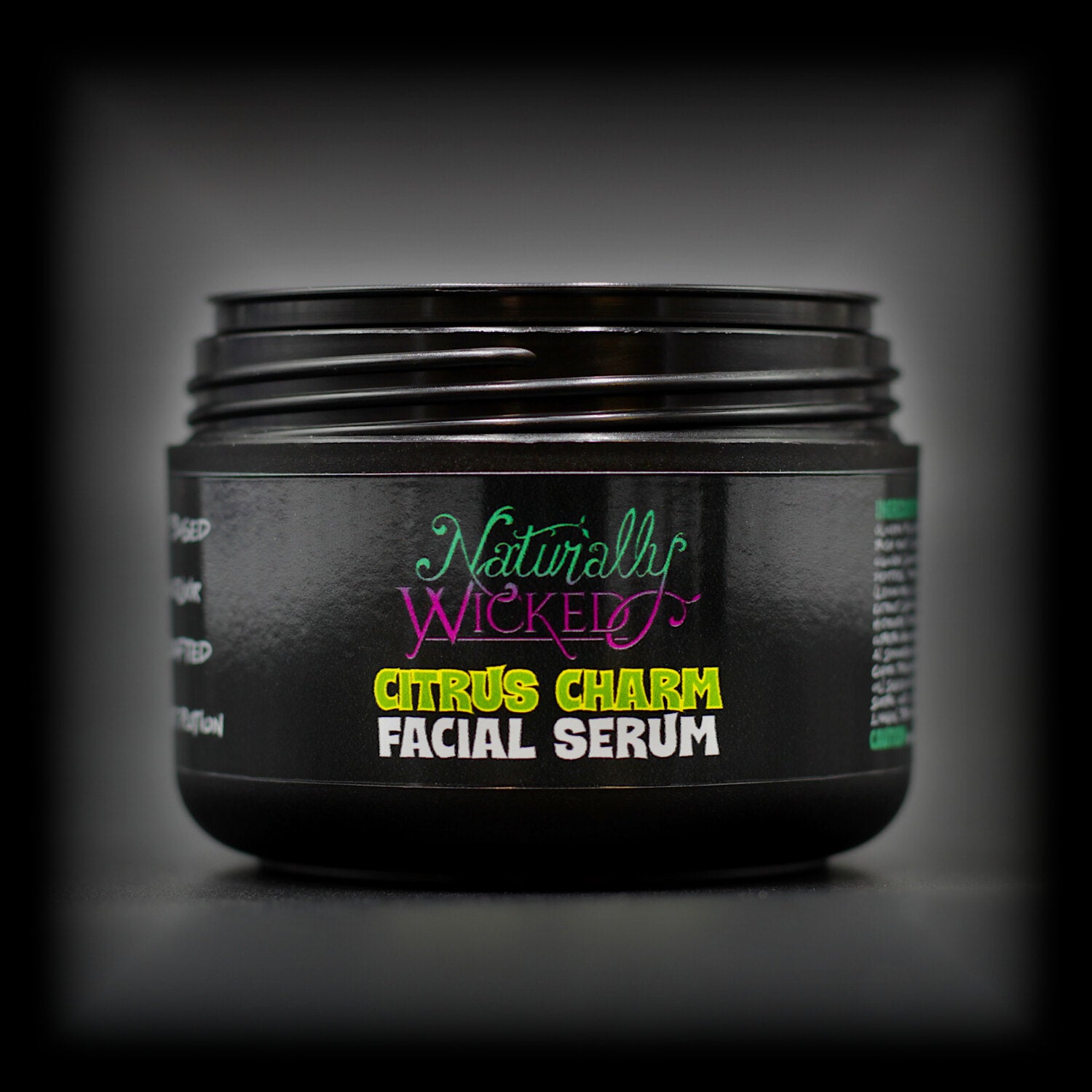 Naturally Wicked Citrus Charm Facial Serum jar with lid removed, ready to use.