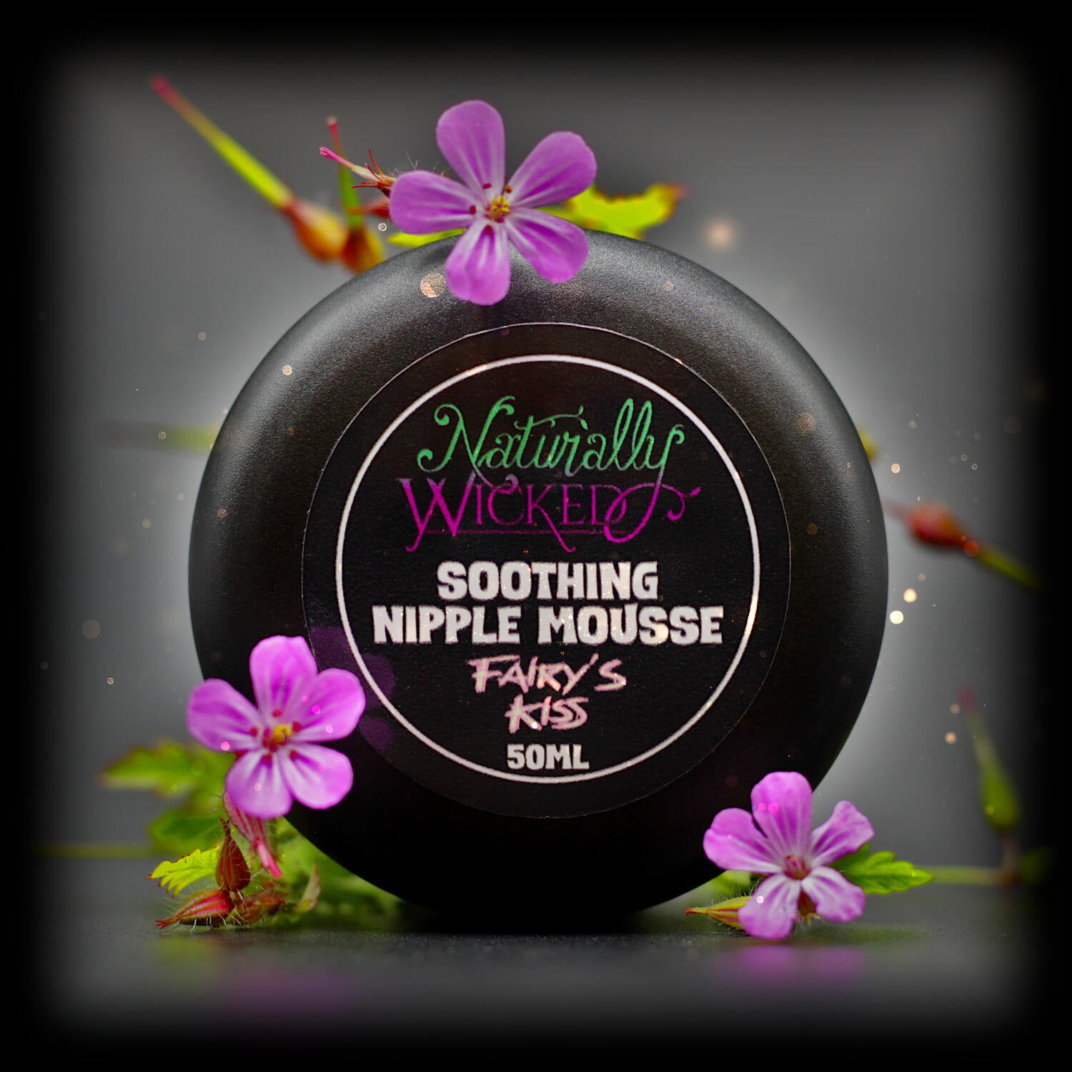 Naturally Wicked Fairy's Kiss Nipple Mousse Lid Amongst Beautiful Pink Flowers & Magic Fairy Dust