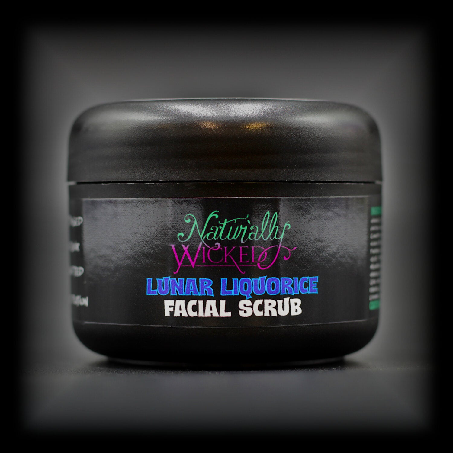 Naturally Wicked Lunar Liquorice Scrub in stylish black packaging, featuring vibrant blue and purple text.
