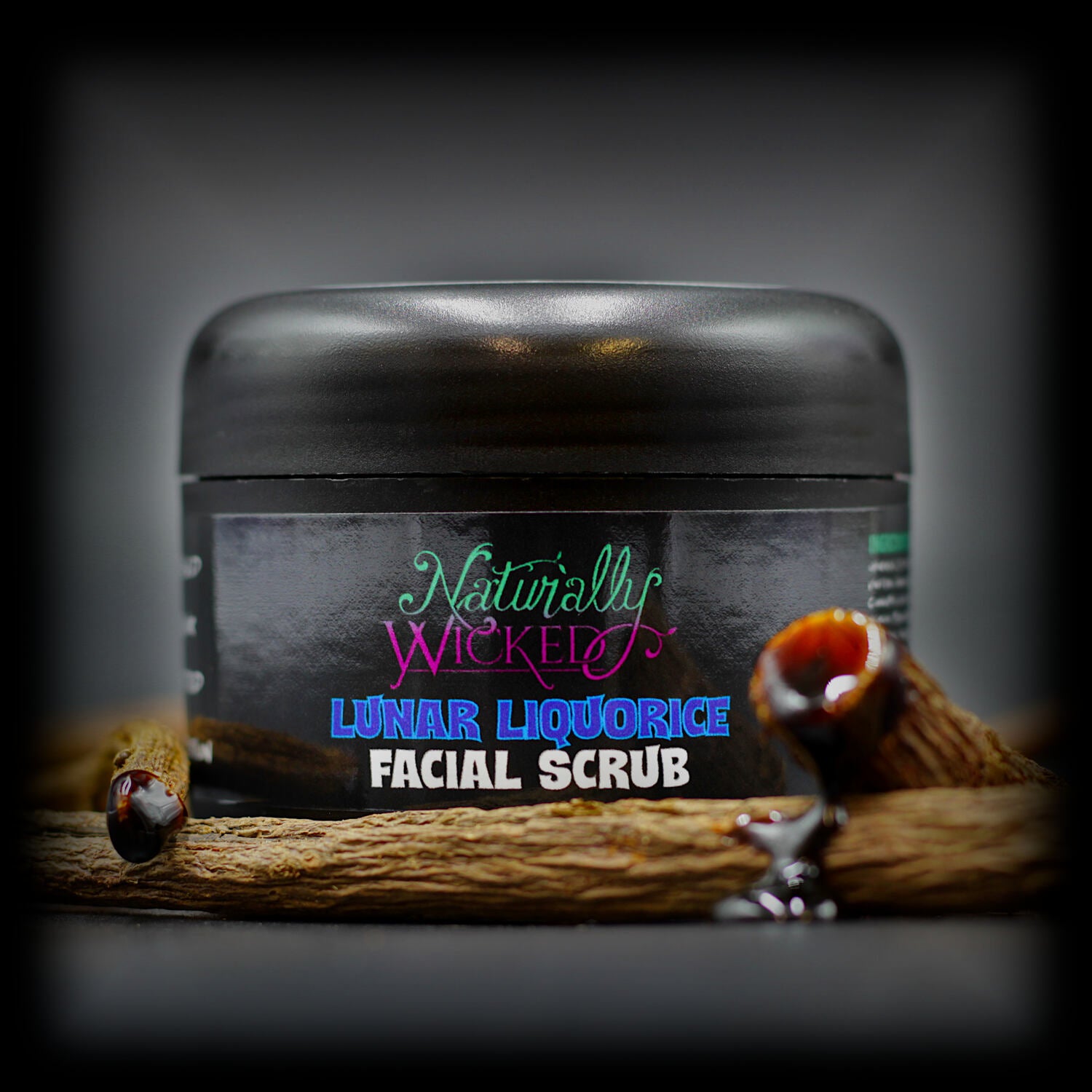 Naturally Wicked Lunar Liquorice Facial Scrub in black tub, styled with natural liquorice root and dripping extract.