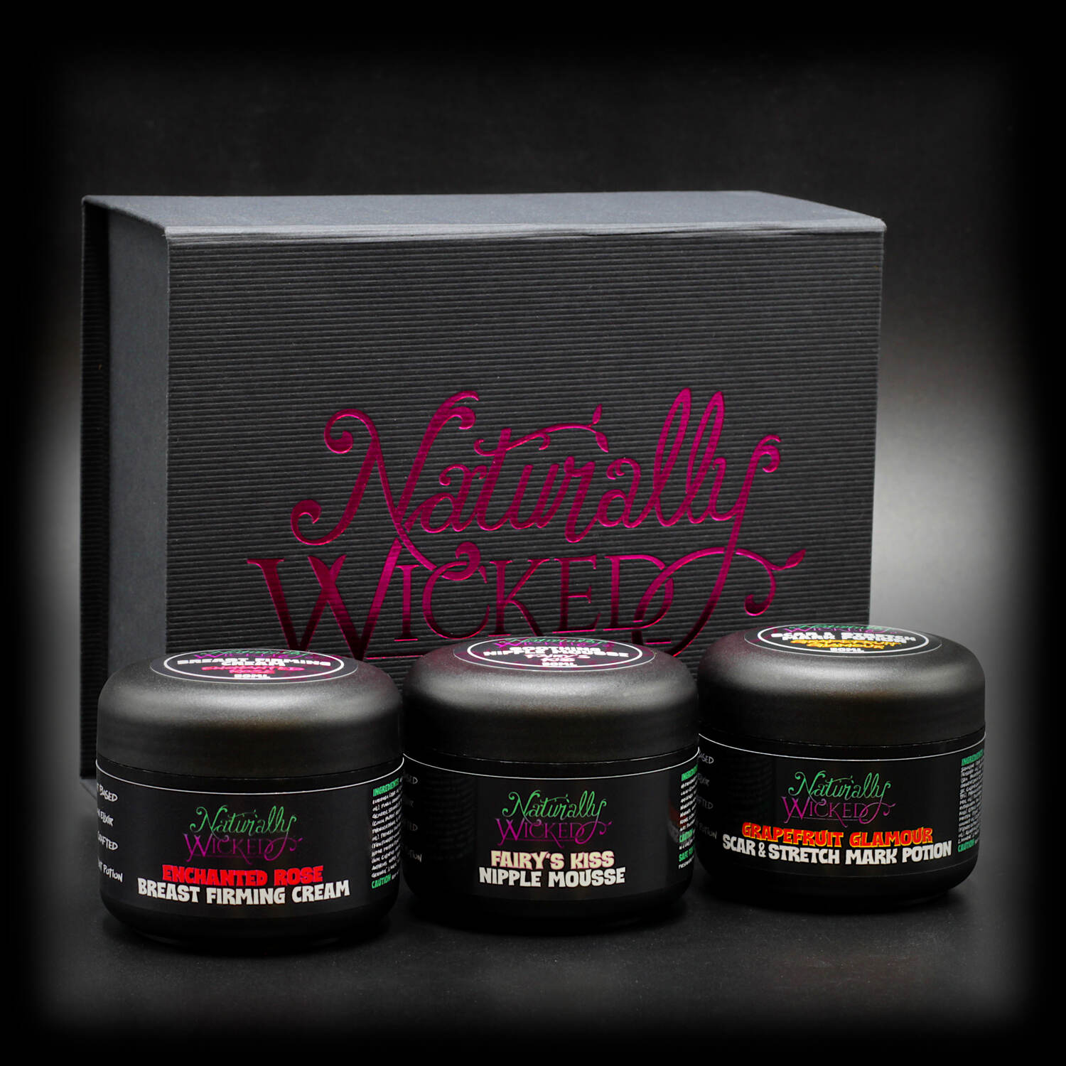 Naturally Wicked Body Care Gift Set featuring Enchanted Rose Breast Firming Cream, Fairy’s Kiss Nipple Mousse, and Grapefruit Glamour Scar & Stretch Mark Potion in a luxurious black box.