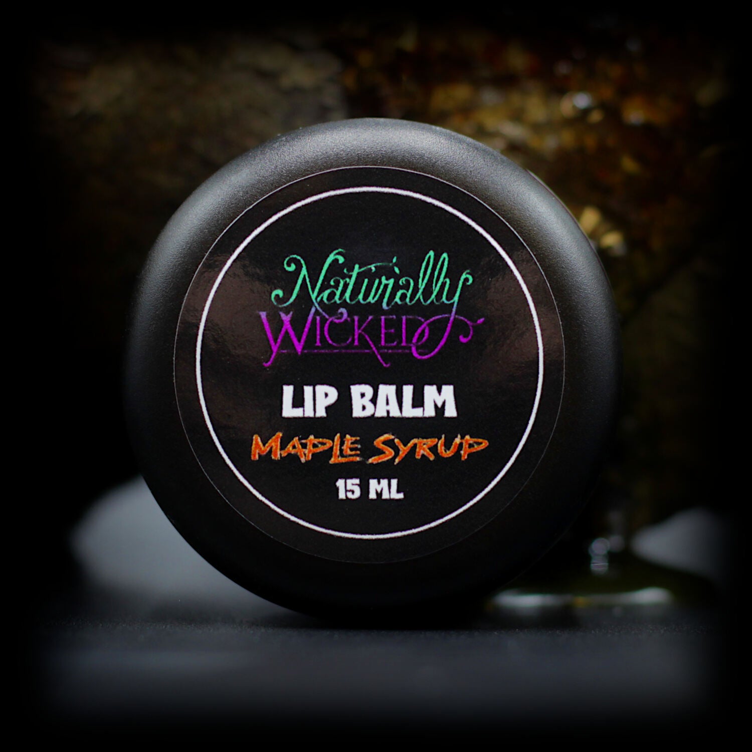 Naturally Wicked Maple Syrup Lip Balm Top Beside Maple Log Drowning In Sweet Maple Syrup Sap