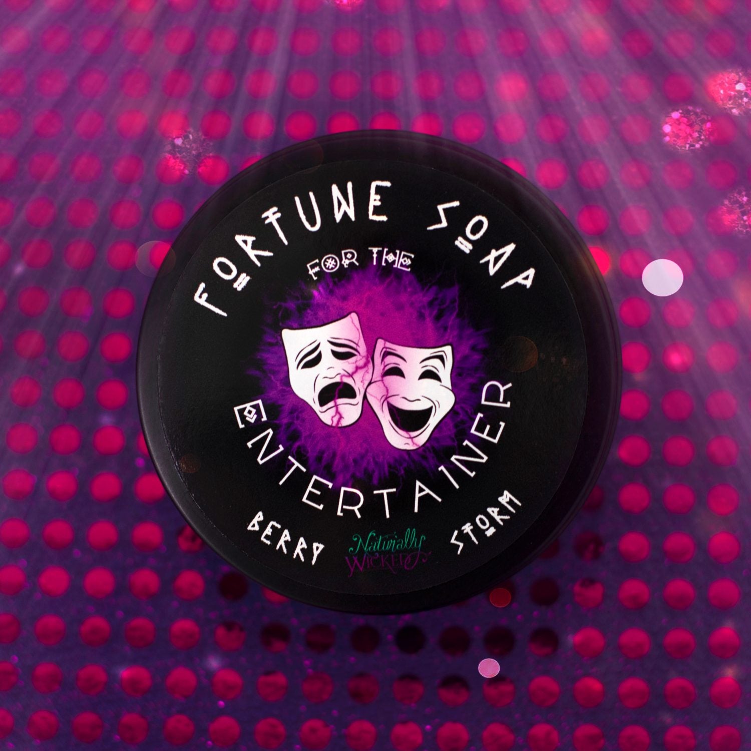 Naturally Wicked Fortune Soap For The Entertainer container with purple and black design on a purple spot lit background