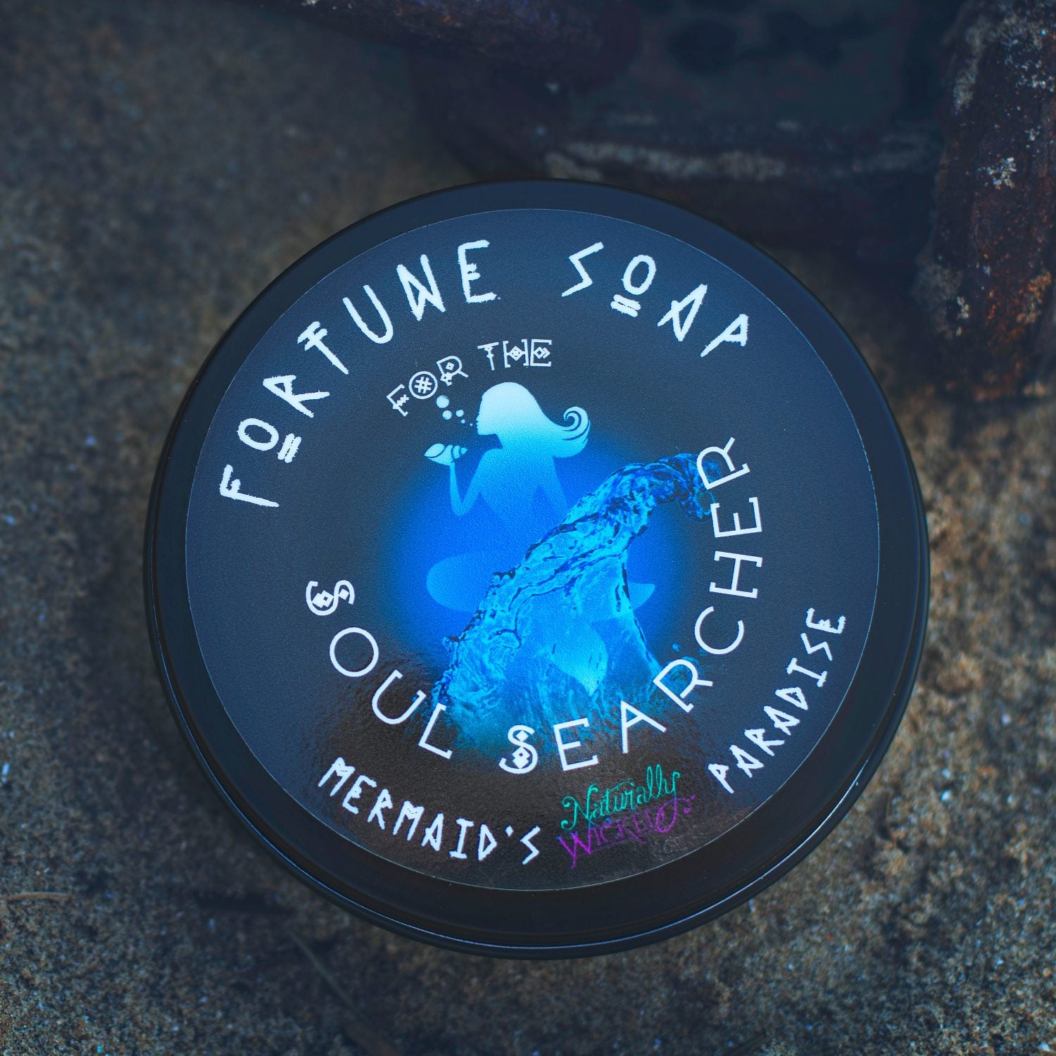 Naturally Wicked Fortune Soap For The Soul Searcher luxury container with a mermaid design on a dark background