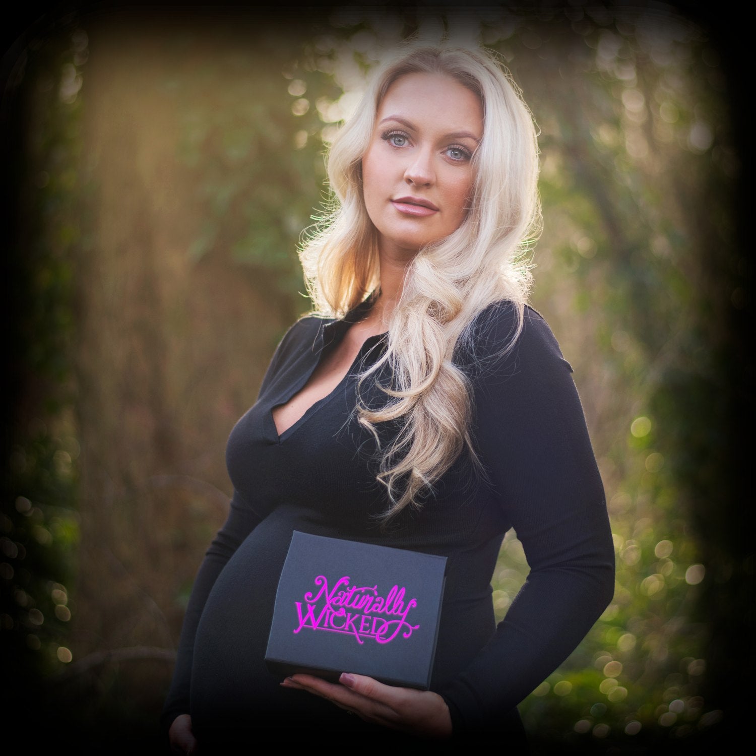 Blonde Pregnant Woman Holding Naturally Wicked 3 Step Mamma Kit