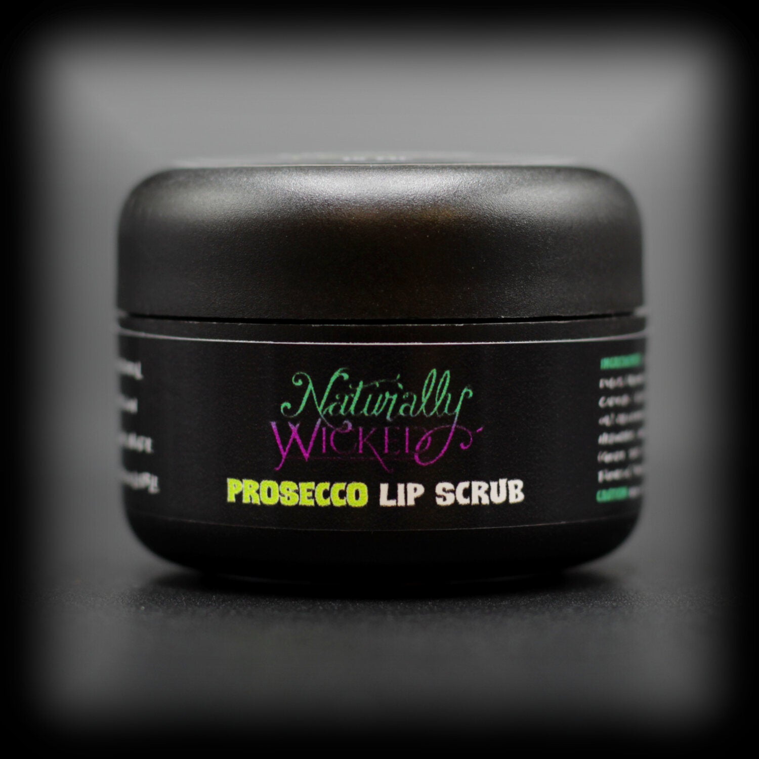 Naturally Wicked Prosecco Lip Scrub With Natural & Vegan Ingredients In Luxury Black Container On Dark Background