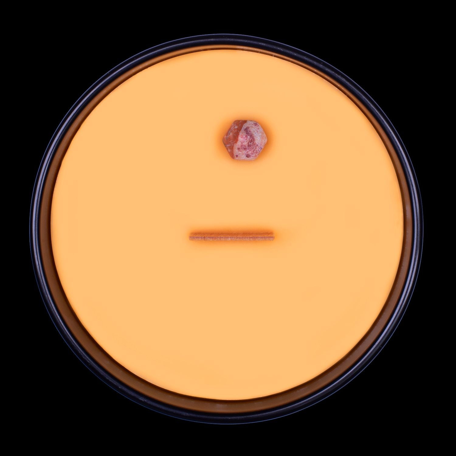 Naturally Wicked Voodoo Pain Crystal Candle View From Above Shows Orange Smooth Plant-based Wax, Featuring A Wooden Wick And Leopardskin Jasper Crystal Wand. All Situated Within A Black Gloss Glass Container.