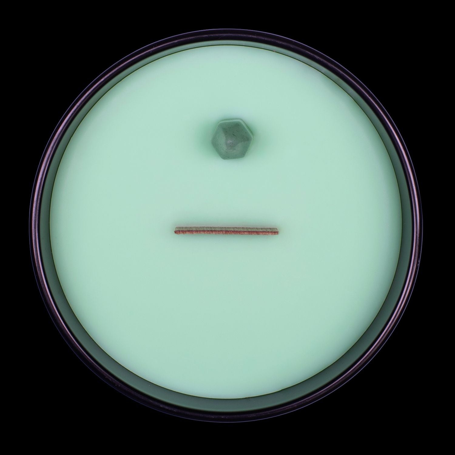 Naturally Wicked Voodoo Wealth Crystal Candle View From Above Shows Green Smooth Plant-based Wax, Featuring A Wooden Wick And Green Aventurine  Crystal Wand. All Situated Within A Black Gloss Glass Container.