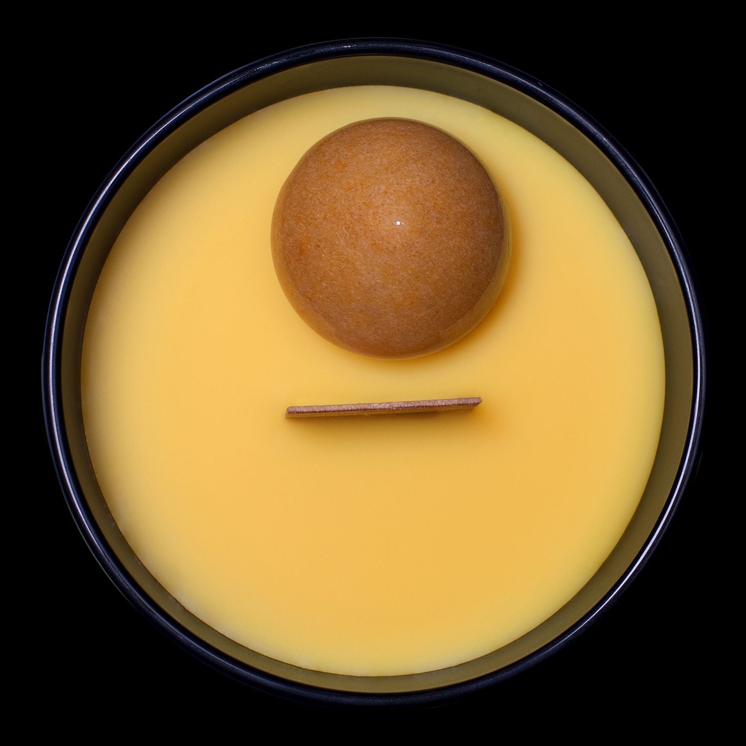 Birds Eye View Of The Naturally Wicked Hypnotwist Enjoy Candle Featuring Plant-based Soy Yellow Wax Scented With Banana Splits Breeze & Includes A Yellow Jade Crystal Spinning Top & Wooden Wick