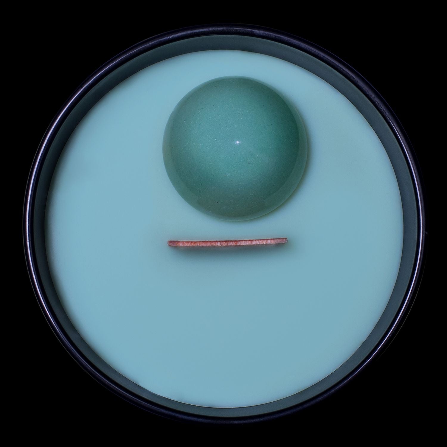 Birds Eye View Of The Naturally Wicked Hypnotwist Focus Candle Featuring Plant-based Soy Green Wax Scented With Archer's Apple & Includes A Green Aventurine Crystal Spinning Top & Wooden Wick