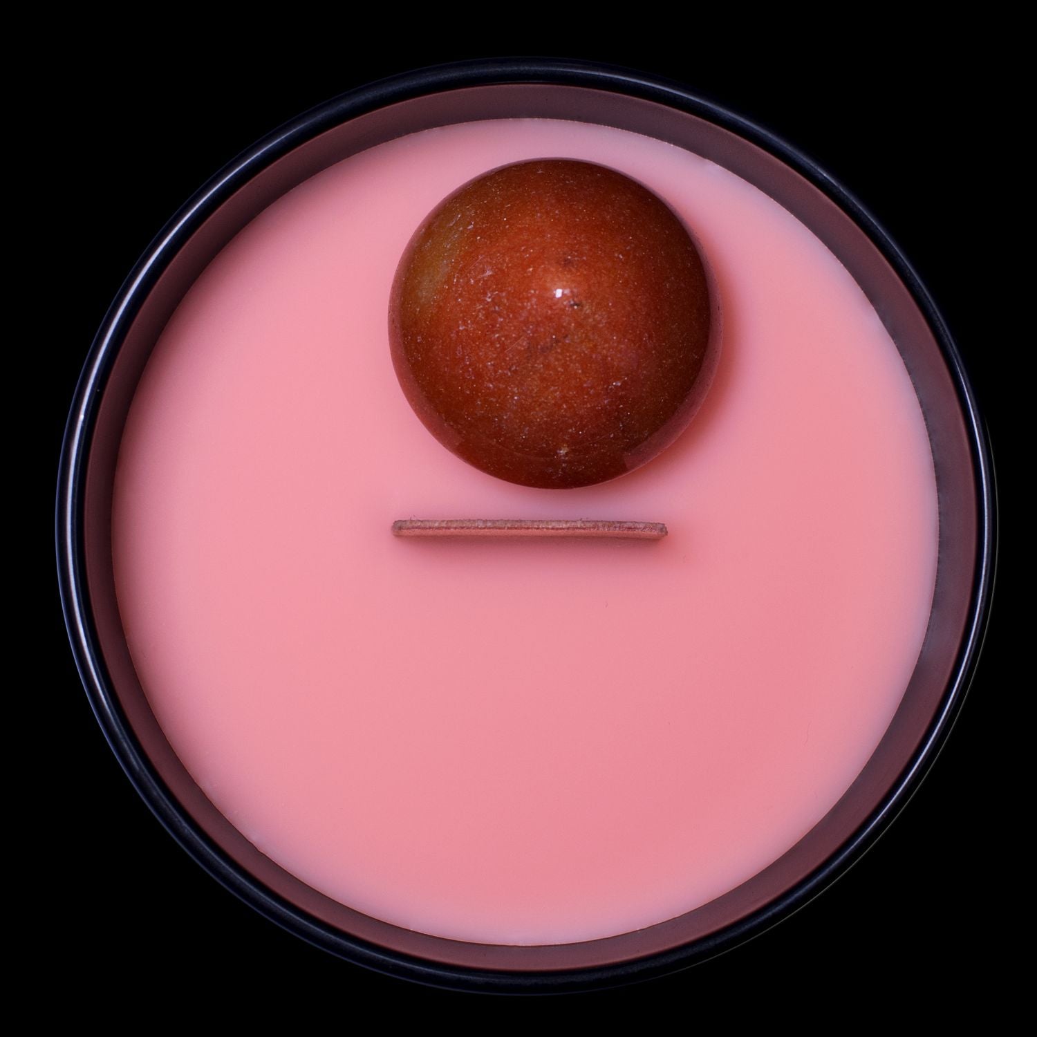 Birds Eye View Of The Naturally Wicked Hypnotwist Forgive Candle Featuring Plant-based Soy Orange Wax Scented With Puppeteer's Punch & Includes An Orange Aventurine Crystal Spinning Top & Wooden Wick