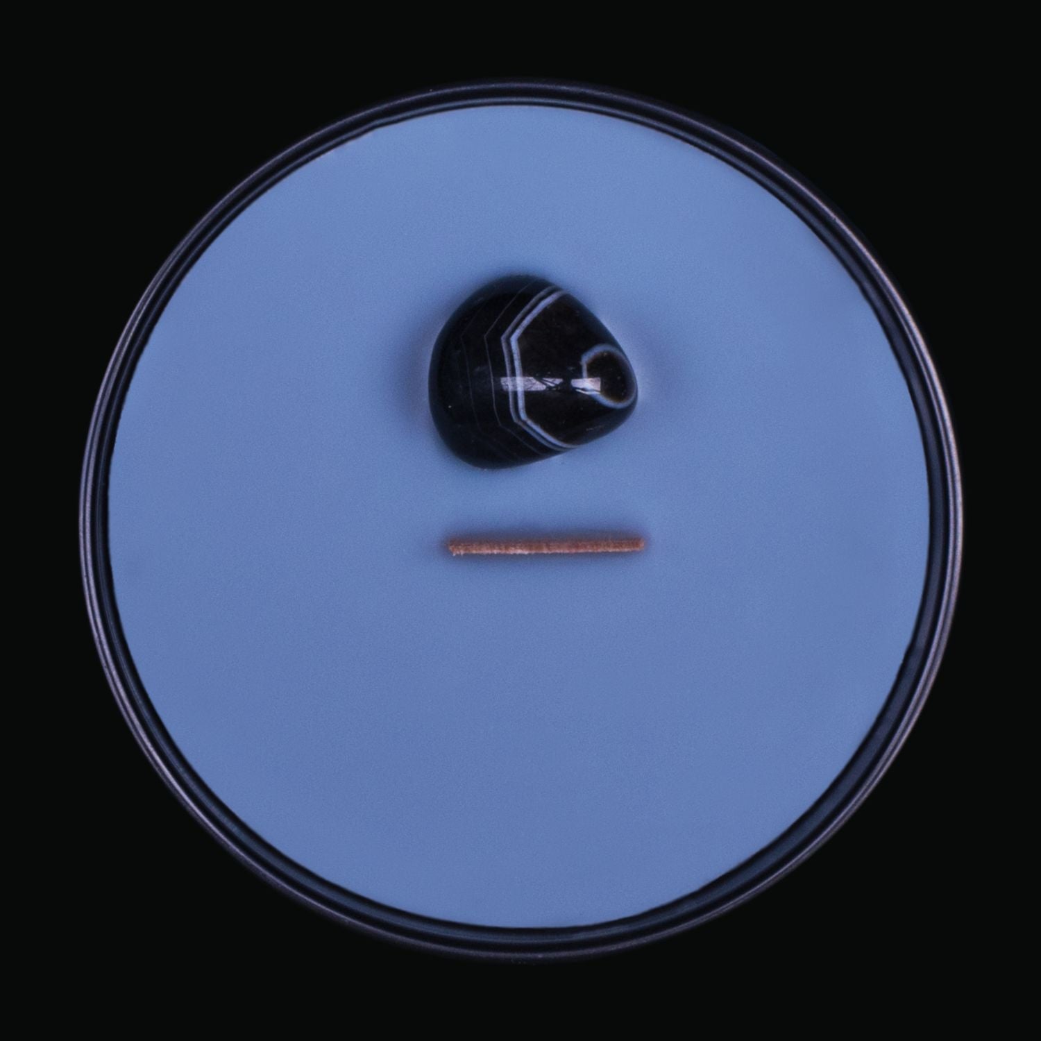 Naturally Wicked Spellbinding Money Crystal Candle View From Above Shows Black Smooth Plant-based Wax, Featuring A Wooden Wick And Black Onyx Spell Crystal. All Situated Within A Black Gloss Glass Container. A Truly Unique Gift